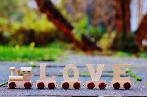 wooden toy train with the inscription love