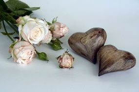 bouquet of roses and two wooden hearts