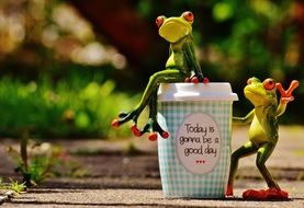 frogs figures with coffee in beautiful day