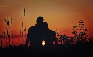 landscape of silhouette of a couple in love on sunset background