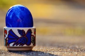 blue shiny easter egg in stand