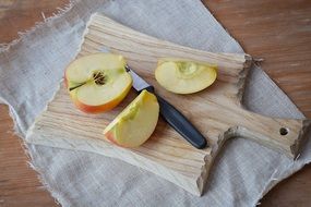 sliced apple on a wooden board