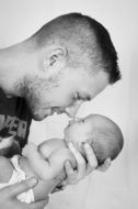 Monochrome portrait of happy young Father with Baby Son in hands