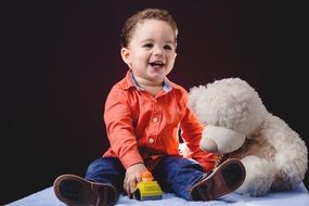 portrait of a baby boy with toy car