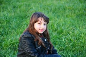 cute young girl on green grass