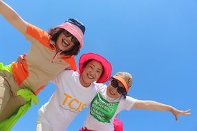 photo of smiling sisters in multi-colored panama