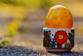 brightly colored easter egg in a stand