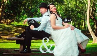 wedding couple posing on the bench