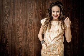 beautiful model posing on a wooden surface background