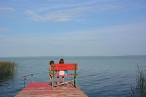 Children fishing on pond at summer