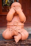 stone buddha statue with mouth closed