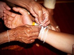 tying thread on the hand