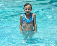 smiling girl in the blue pool