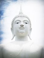 white buddha statue in white clouds