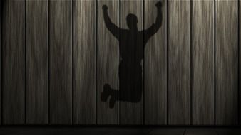 shadow of jumping man on wooden wall, illustration