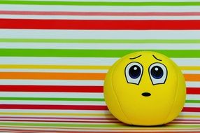 yellow ball with apologetic face