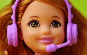bright doll in headphones with a microphone