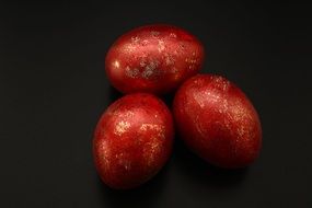 three easter eggs on black background