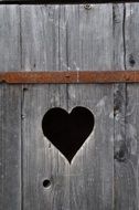 heart-shaped window in the wooden surface