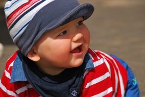 little baby in a striped cap