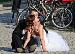 bride with groom on the background of parked bicycles