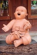 clay figure of laughing Buddha