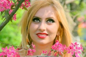 girl with bright makeup among the bloom