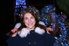 girl with Christmas decorations in a warm jacket