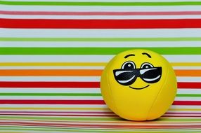soft smiley in glasses on a striped background