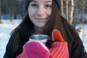 happy Teen Girl with Cup of hot drink outdoor at Winter