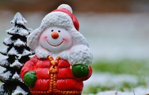 cute colorful ceramic snowman in the clothes in winter