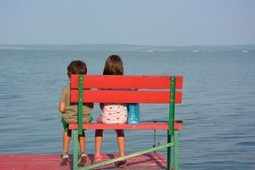 children on a bench by the sea