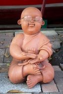 figure of Buddha in glasses