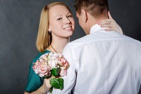 young happy couple with flowers on photo shoot