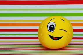 ball with a playful emoticon