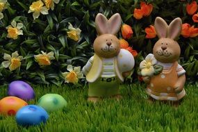 figures of easter bunnies on green grass