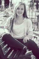 beautiful girl on a bench in black and white