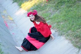 Girl with a red wreath of roses