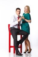 young couple in a red chair at a photo session