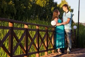 Future parents near the wooden fence