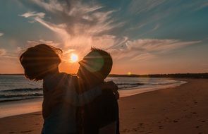 happy people on the beach at sunset time