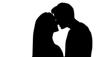 silhouette of a kissing couple in love