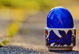 blue brilliant egg in a porcelain stand