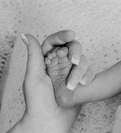 baby foot in mother's hand