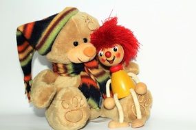 teddy bear and wooden doll