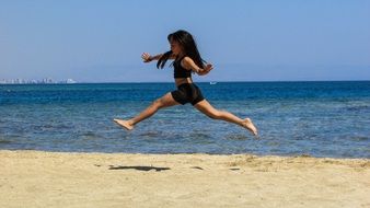 jumping girl on the beach