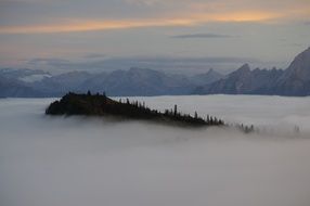 gorgeous landscape with Mountains at sky above Fog