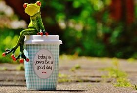 Coffee to go and frog figure