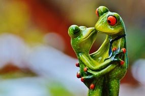 figure of green frogs in an embrace