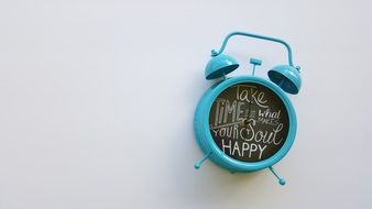 turquoise alarm clock with inscriptions